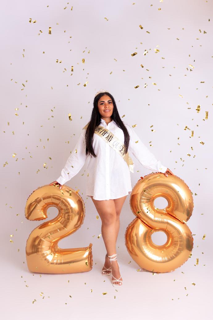 Birthday portrait with gold number balloons