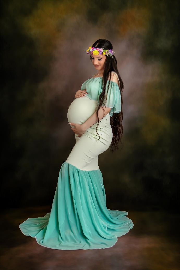 Outdoor maternity portrait in green dress